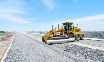Motor grader finishing base course
